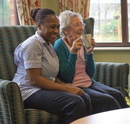 MHA carer and resident enjoy a cup of tea together