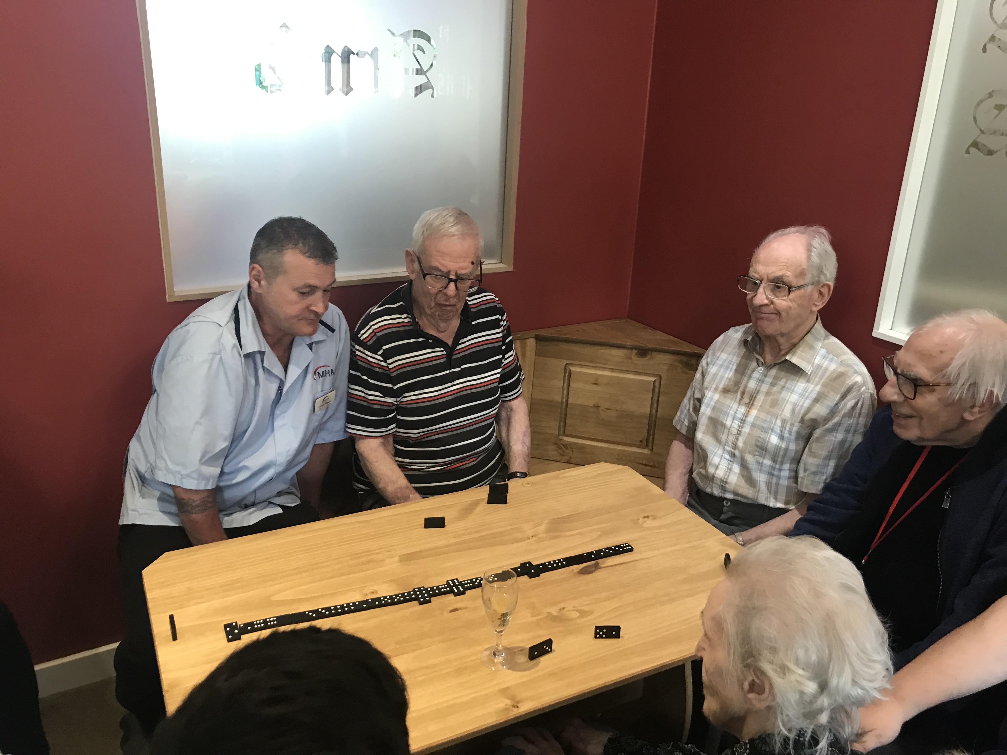 residents at Abbey Park care home enjoying a game of dominoes in their own pub
