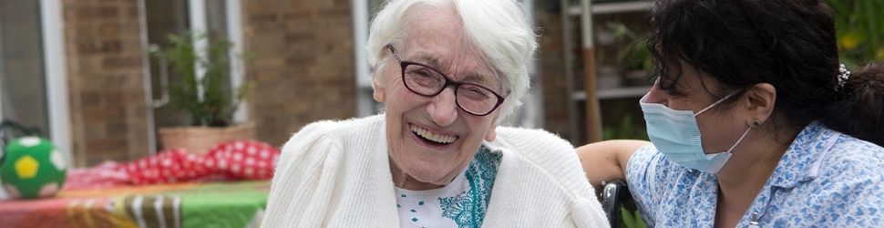 Female resident laughing with carer 970x250 3.jpg